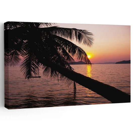 Large beach wall art featuring a stunning sunset over the ocean with a leaning palm tree silhouette.