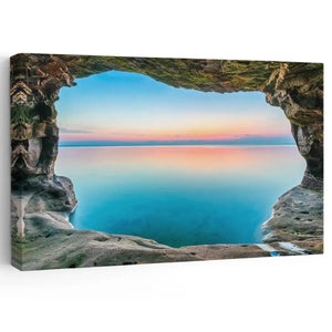  Large beach wall art featuring a breathtaking sea cave opening to a sunset-lit ocean, perfect for coastal decor.