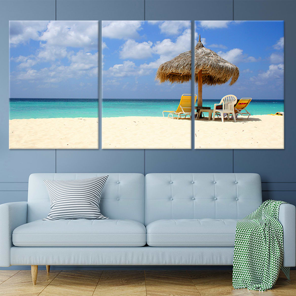 Tropical coastal canvas print depicting a thatched umbrella and lounge chairs.