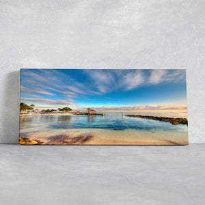 Beach wall art for living room with a breathtaking view of a Bahamas bay, soft clouds, and vibrant blue waters.