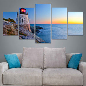  Beach wall art for living room featuring a beautiful lighthouse on a rocky shoreline with waves crashing below.