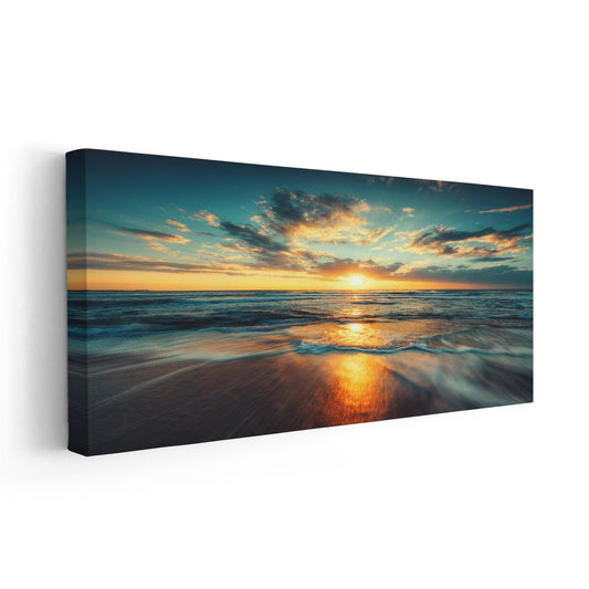 Beach scene canvas art with a glowing sunrise over the ocean.