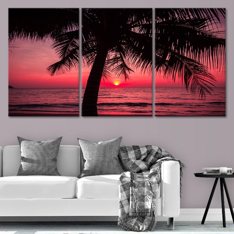 Extra large ocean wall art showcasing a tropical sunset with deep red hues and palm tree shadows.