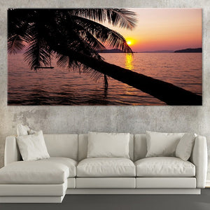 Extra large ocean wall art showcasing a tropical sunset with a palm tree reflecting over the calm waters.