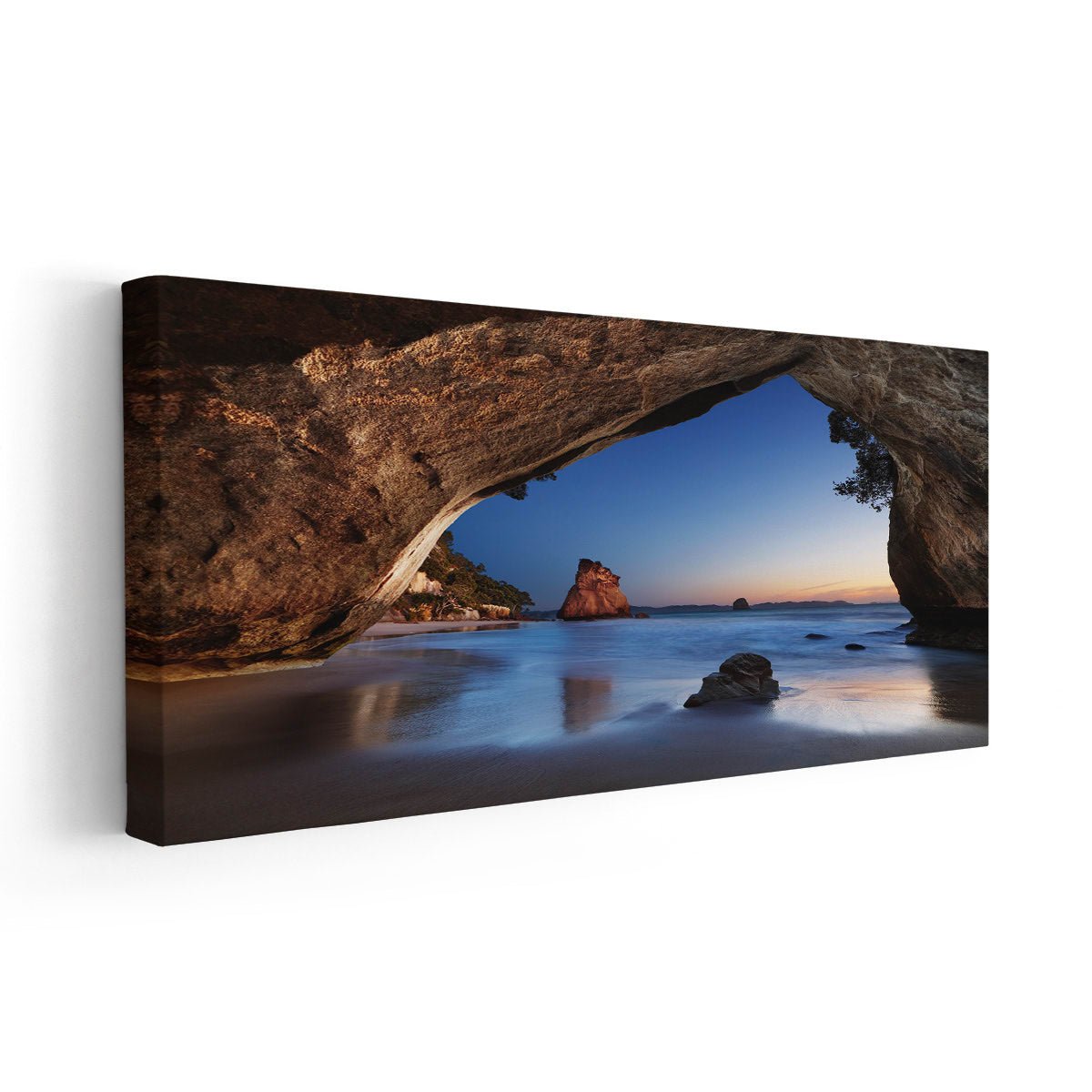 Large canvas beach wall art depicting a serene ocean view framed by rugged cliffs and a glowing sky.