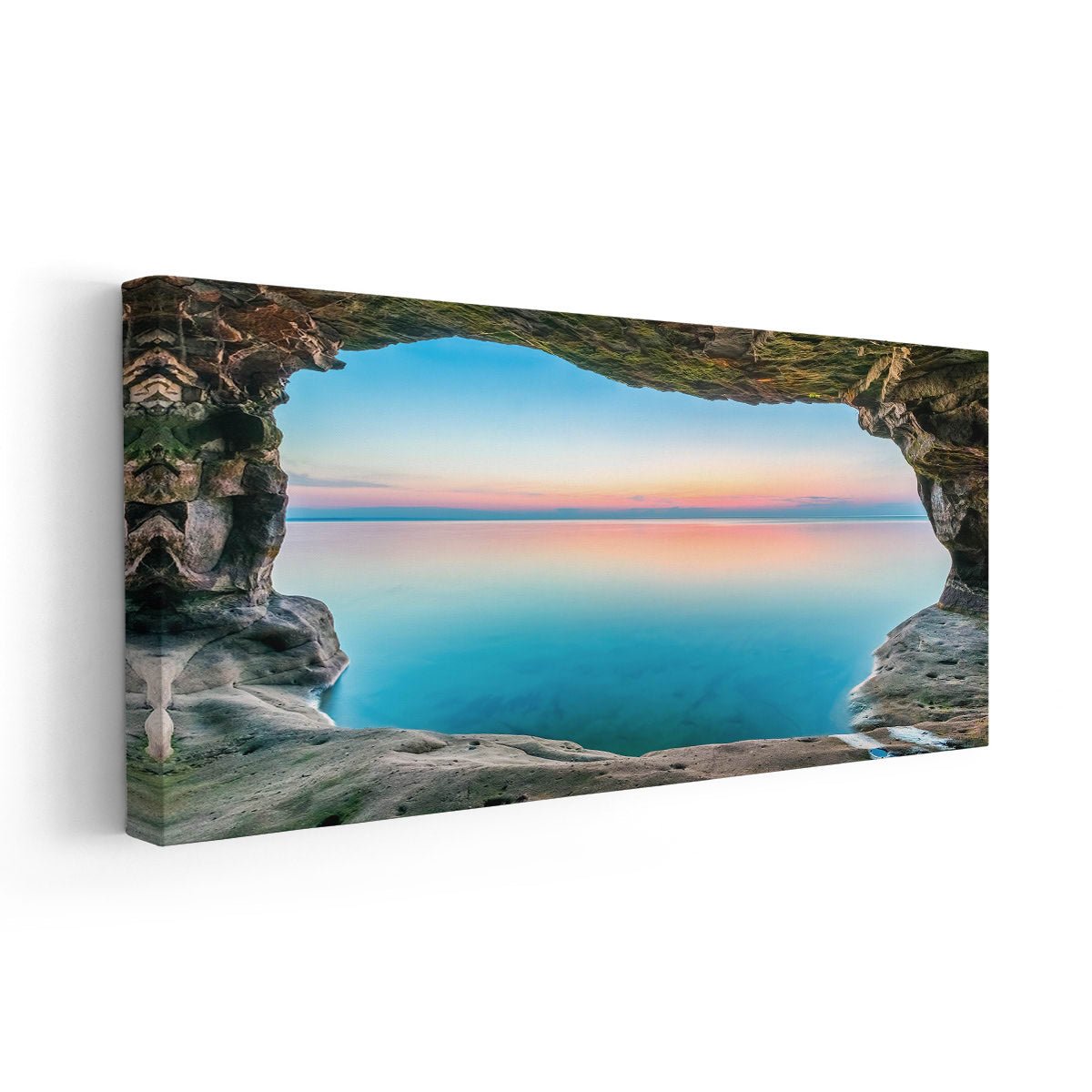 : Large canvas beach wall art depicting a rocky sea cave framing a colorful sunset over the water.