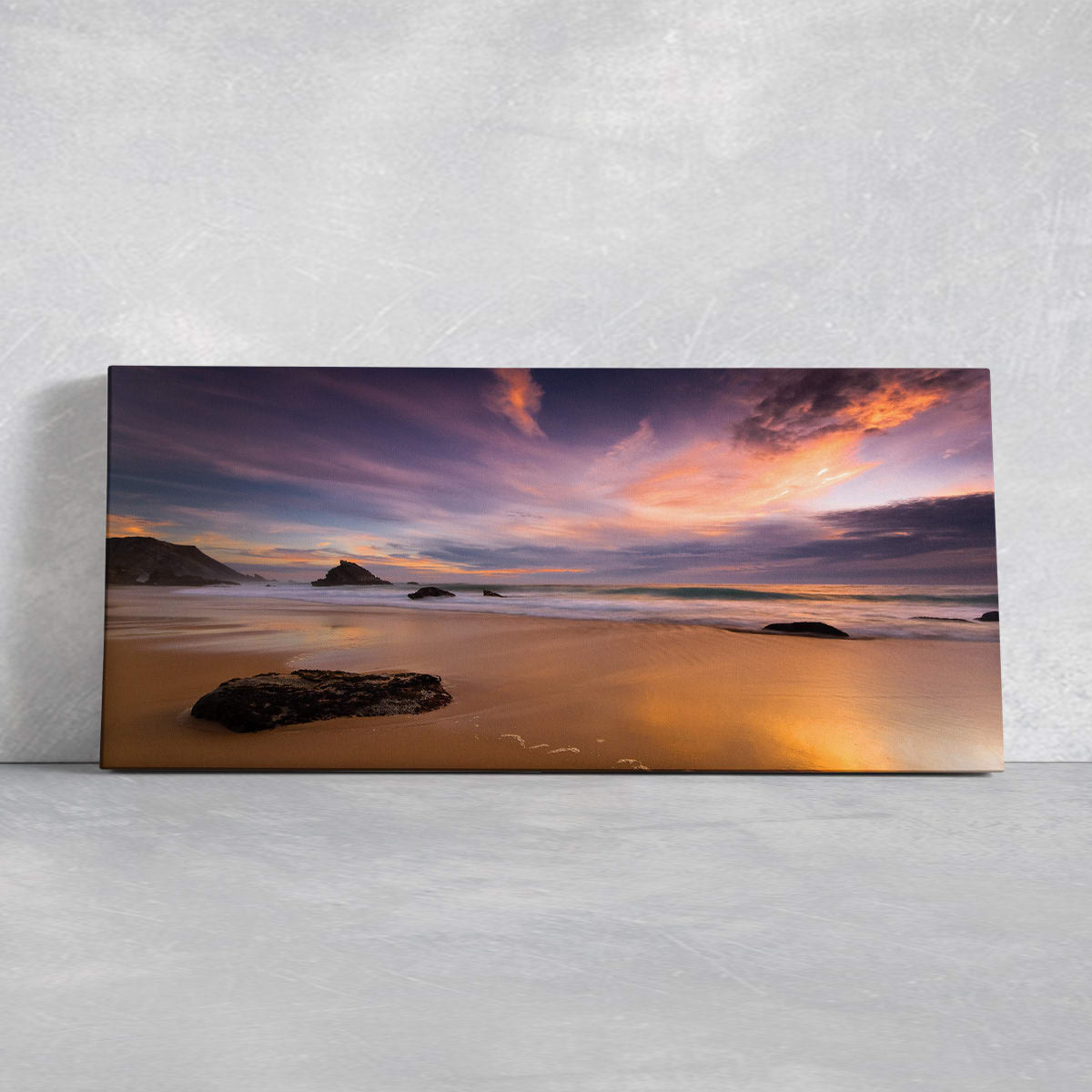  Large wall art ocean scene capturing a dramatic sky at sunset with gentle waves washing onto the shore.