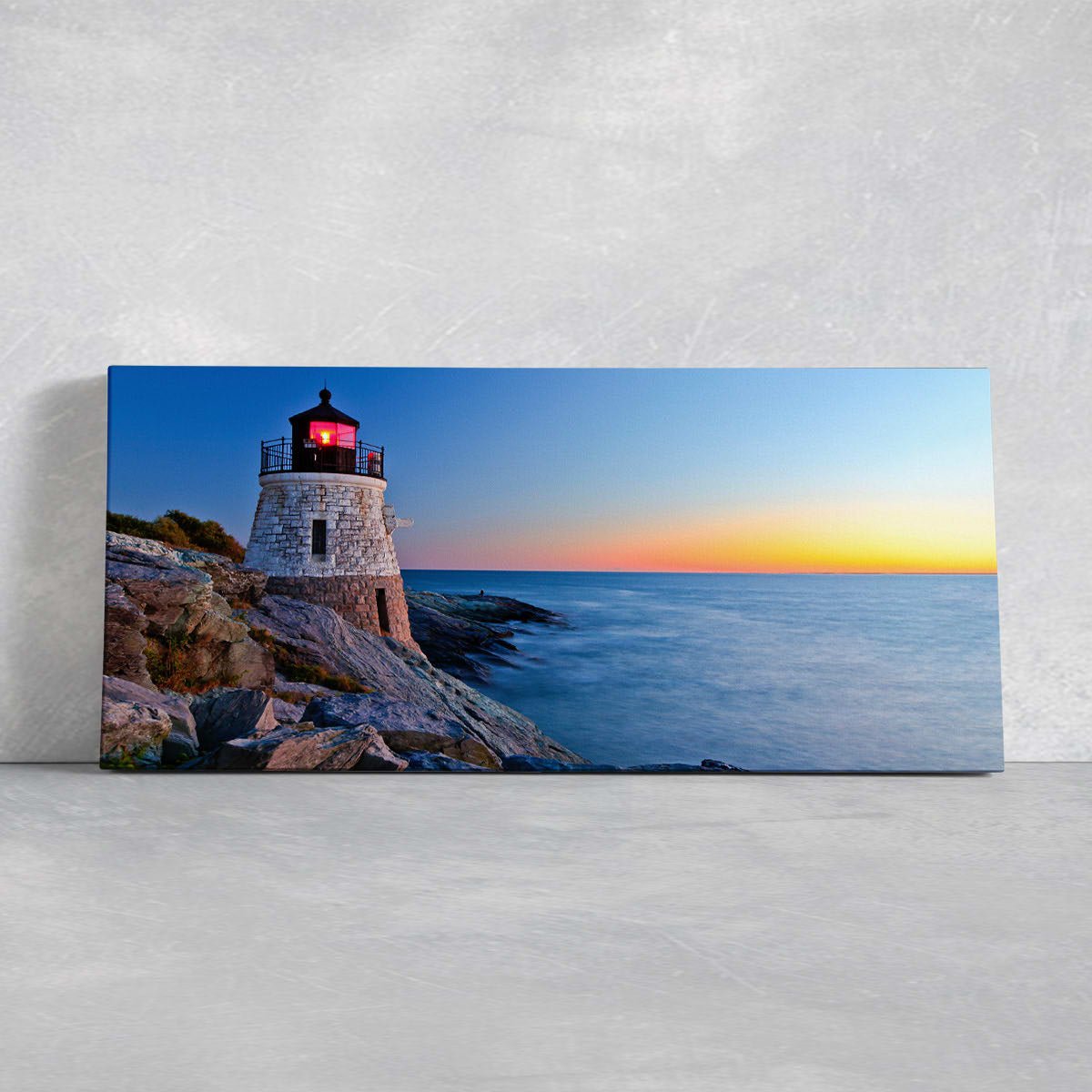  Large wall art ocean scene capturing a scenic lighthouse standing tall against the open sea at sunset.