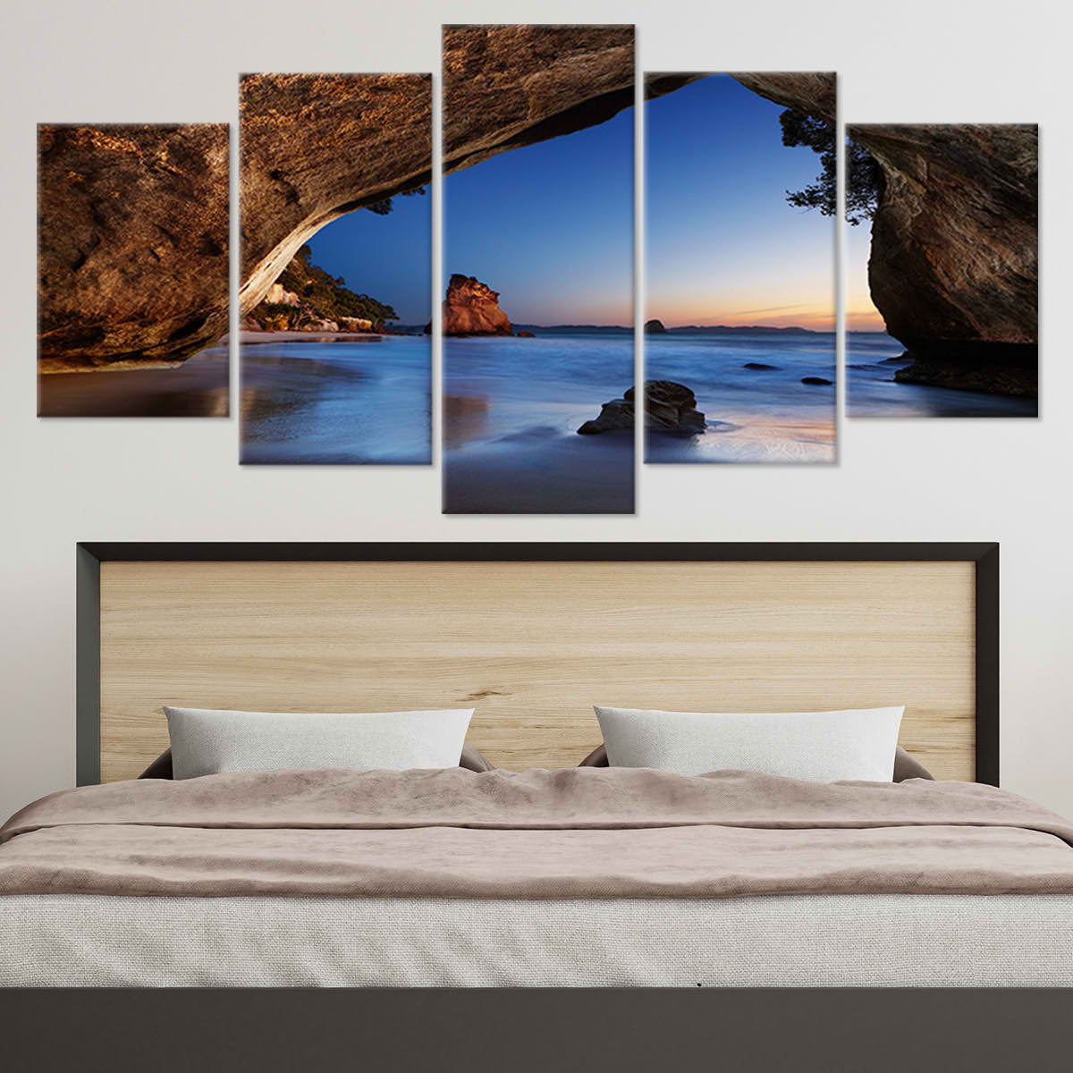  Large wall art ocean scene capturing a scenic natural rock arch leading to a peaceful seascape at dusk.