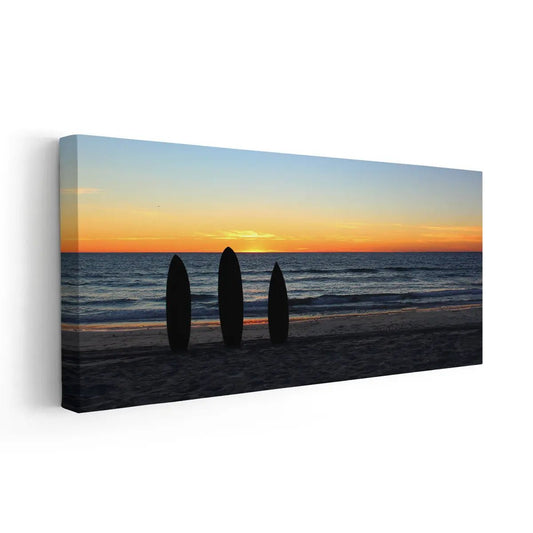 Sunset beach artwork featuring surfboard silhouettes on the shore.